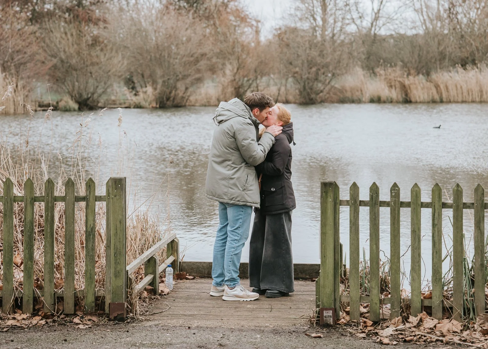  Emotional hug after successful proposal at Clapham Common, quiet romantic London engagement setting. 