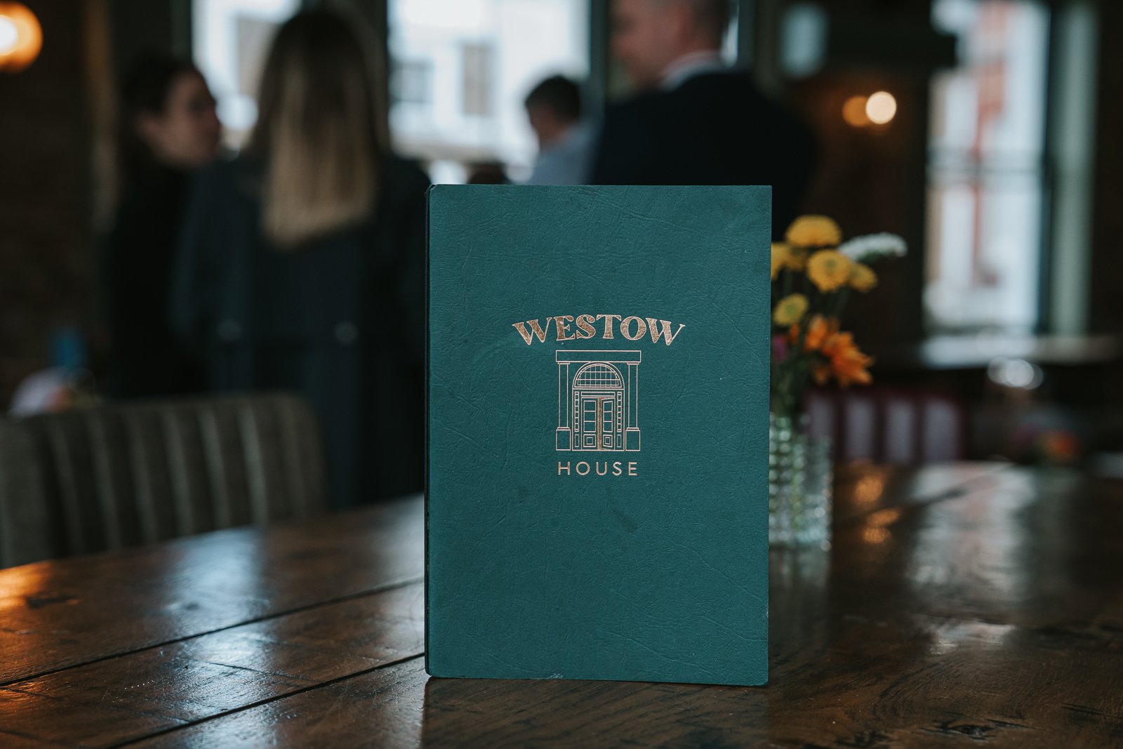  Westow House menu displayed on a wooden table during a christening celebration in Crystal Palace. 