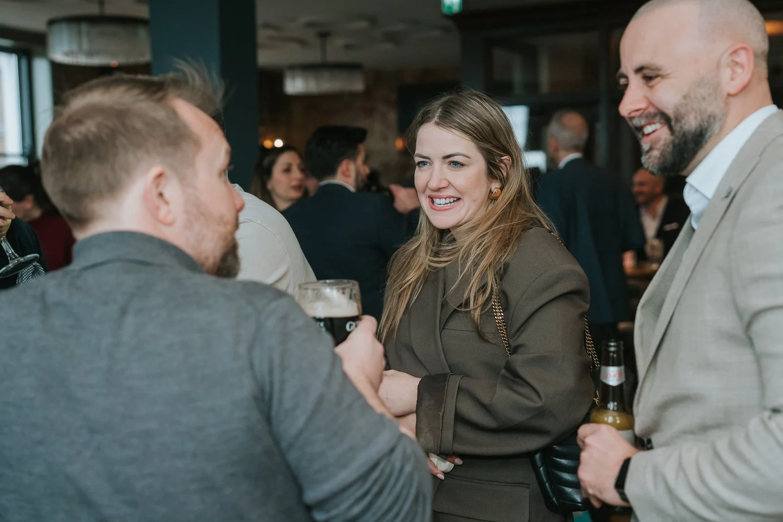  Guests chatting over drinks at a private christening reception at Westow House in South London. 