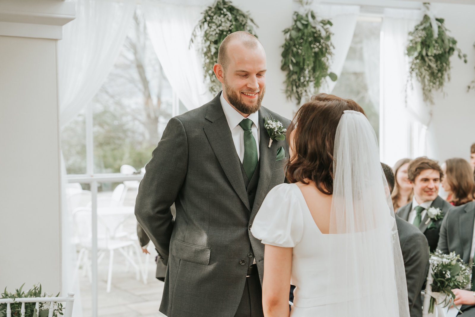  Groom greeting bride in the Belvedere Suite at Pembroke Lodge, Richmond Park wedding venue in South West London. 