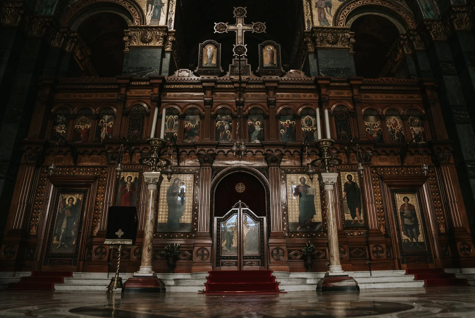  Ornate iconostasis and altar inside Saint Sofia Greek Orthodox Cathedral in Bayswater London with religious icons, carved wood and marble columns 