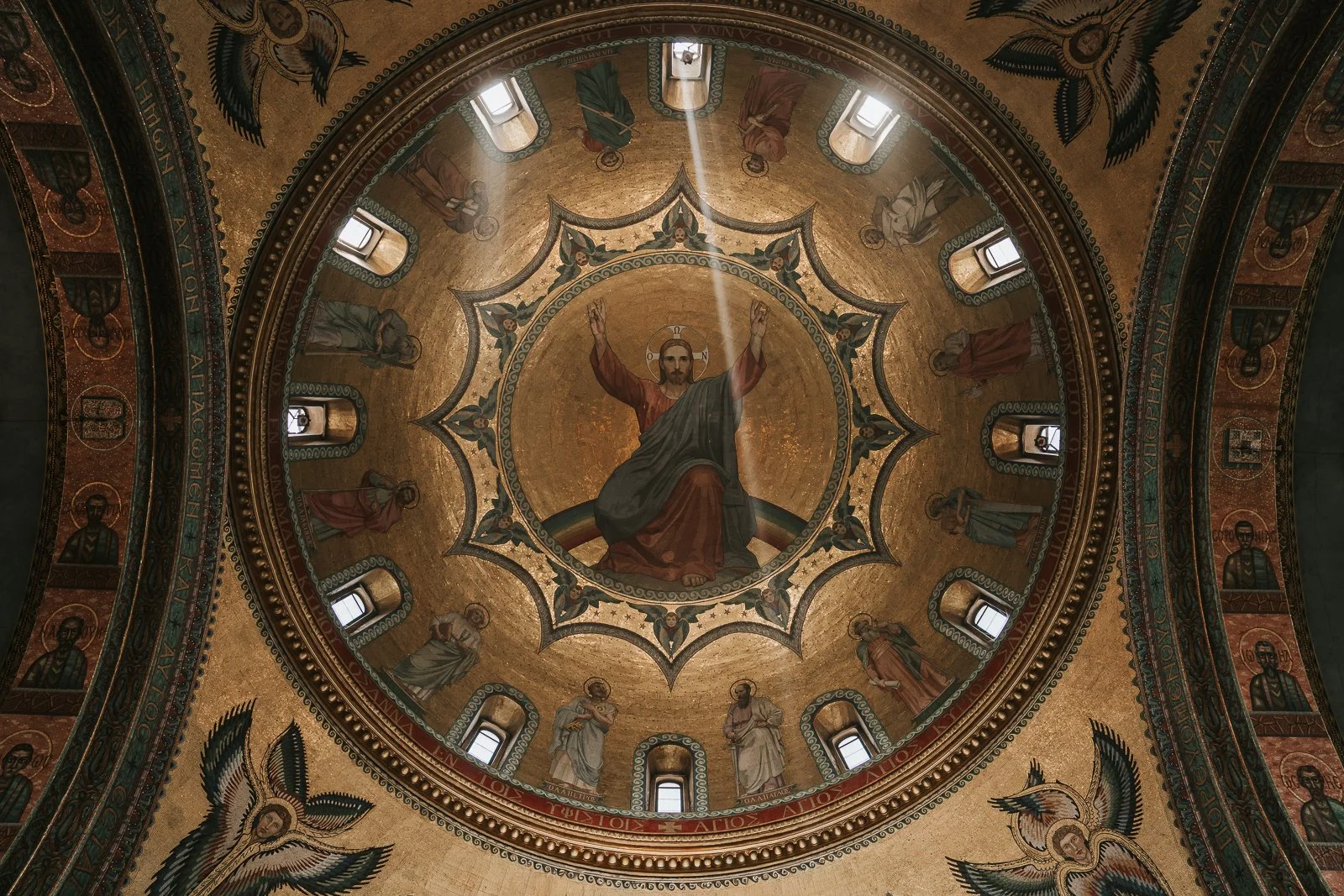  Golden dome ceiling with Christ fresco and light beams inside Saint Sofia Greek Orthodox Cathedral London showcasing detailed Orthodox artwork 