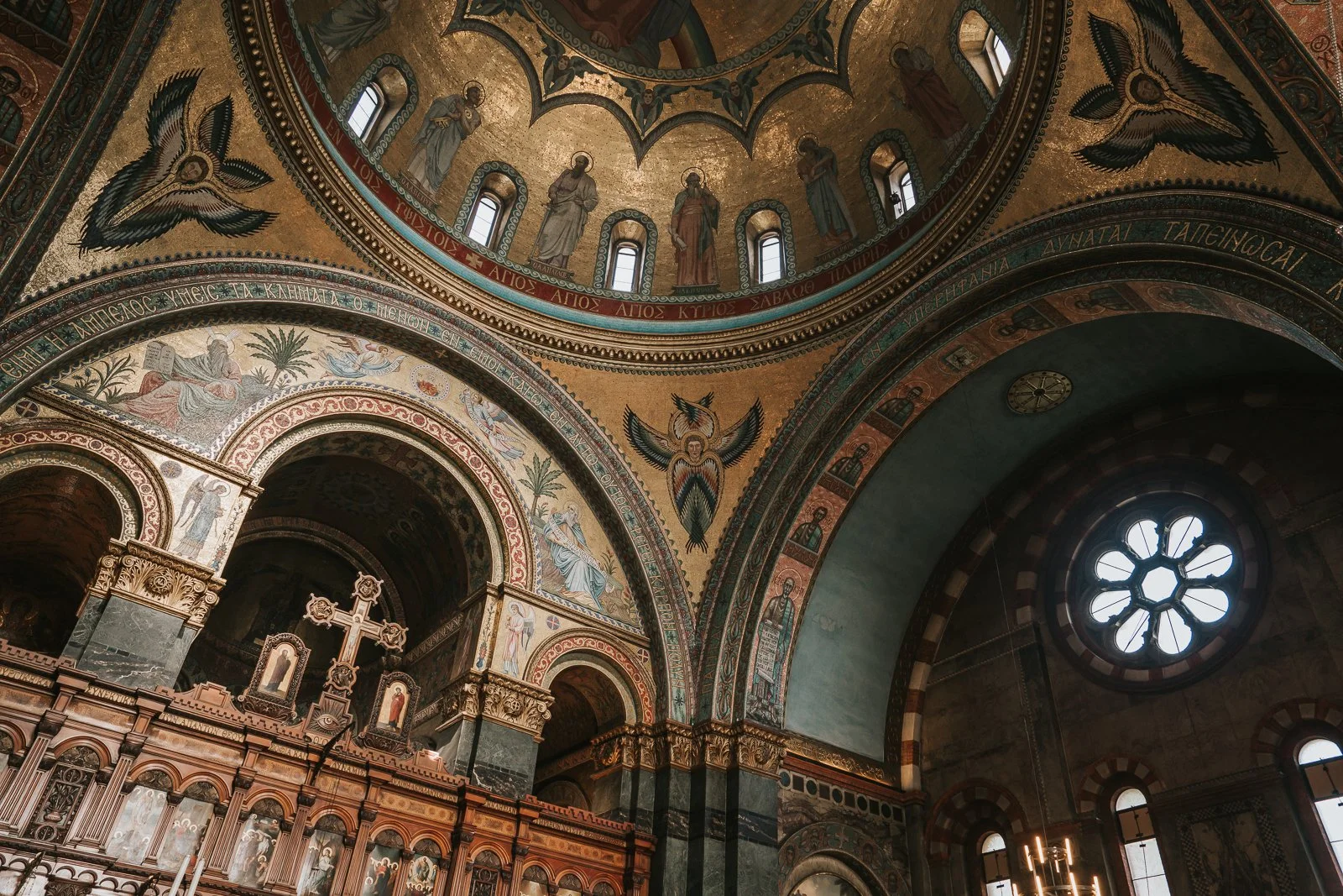  Wide architectural view inside Saint Sofia Greek Orthodox Cathedral in Bayswater London showing ceiling frescoes, arches and iconostasis 
