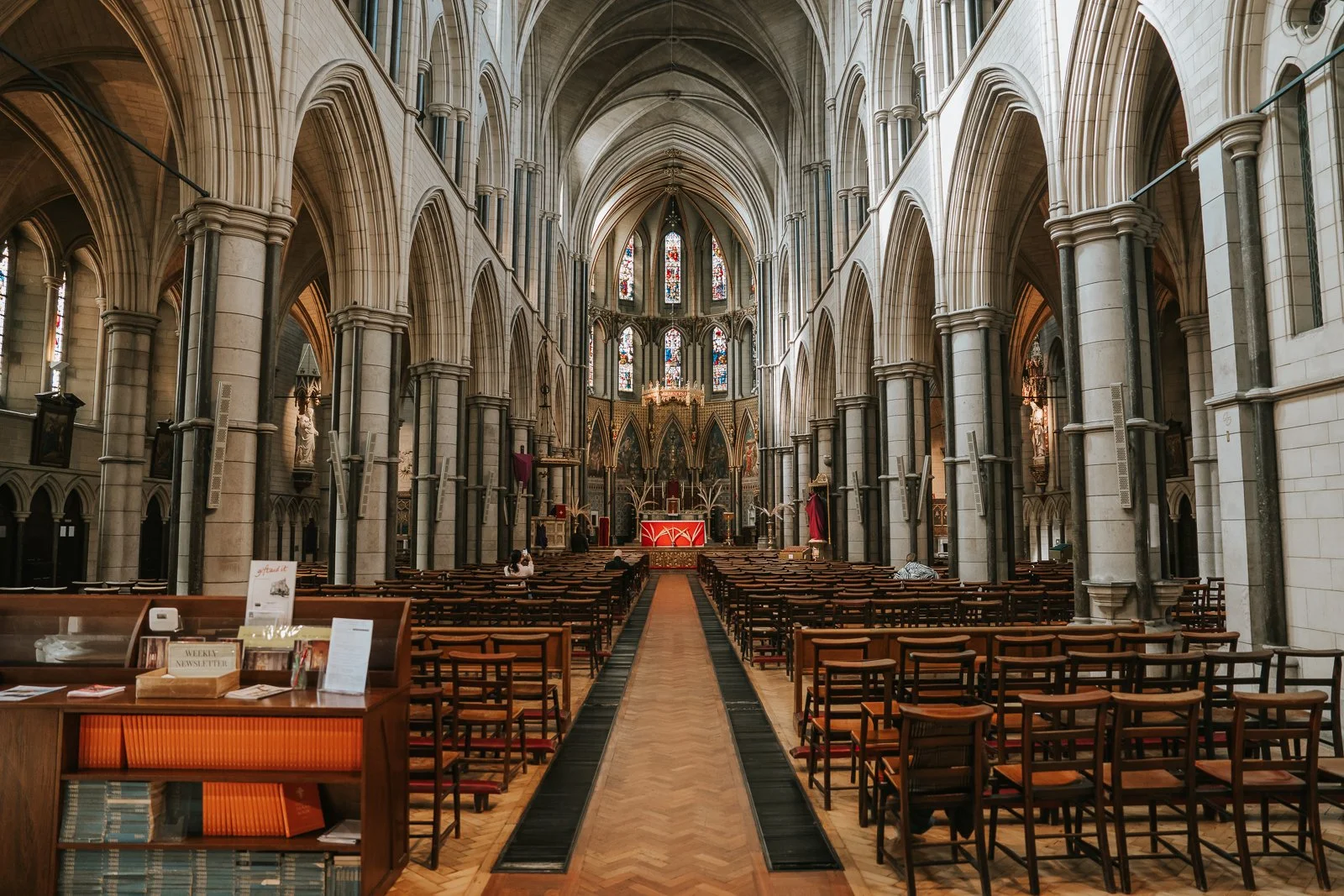  Wide interior of St James’ Catholic Church Spanish Place London showing grand arches, stained glass windows and aisle. 