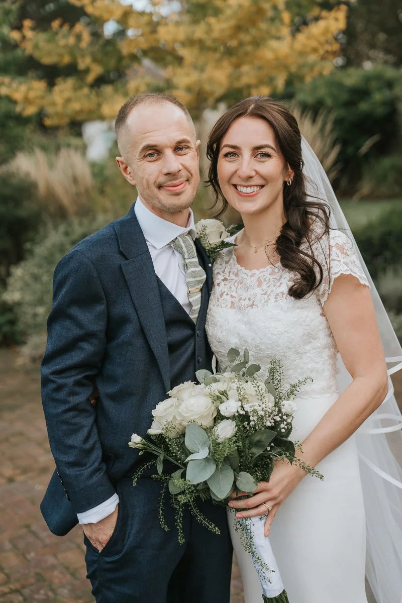  Bride and groom portrait at Morden Park House, South London wedding venue, romantic garden setting with soft greenery, natural documentary wedding photography 