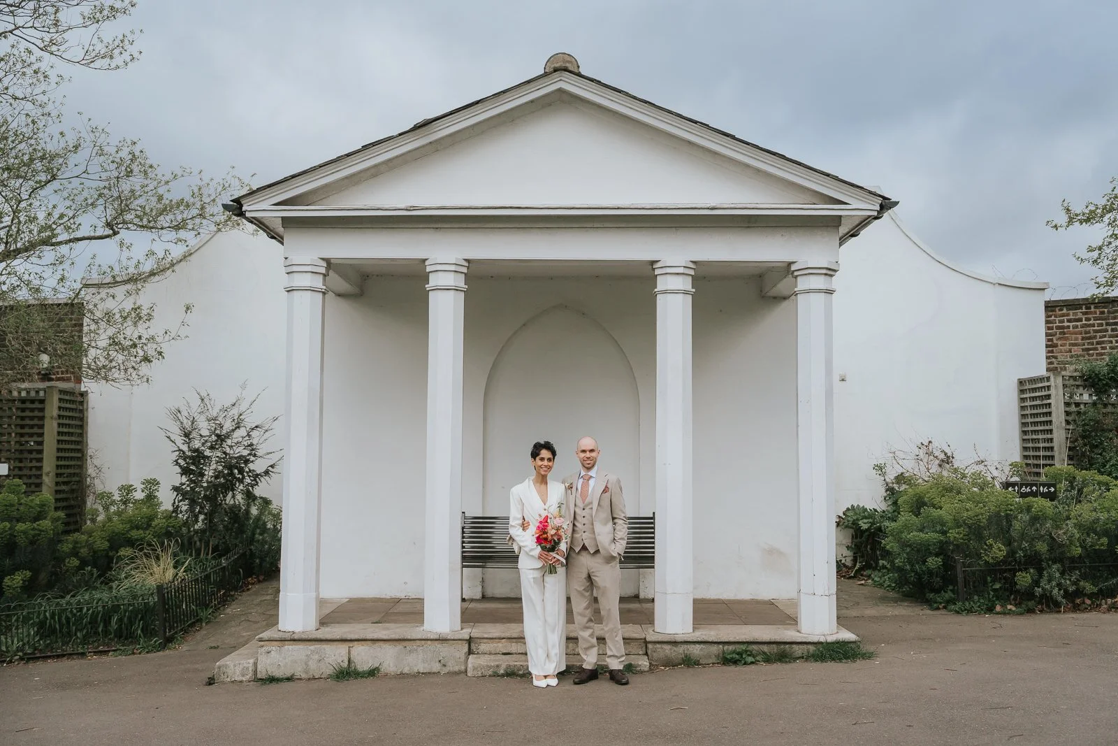  Bride and groom portrait at Brockwell Park pavilion near Brockwell Hall, relaxed South London wedding photography with minimalist architectural backdrop. 