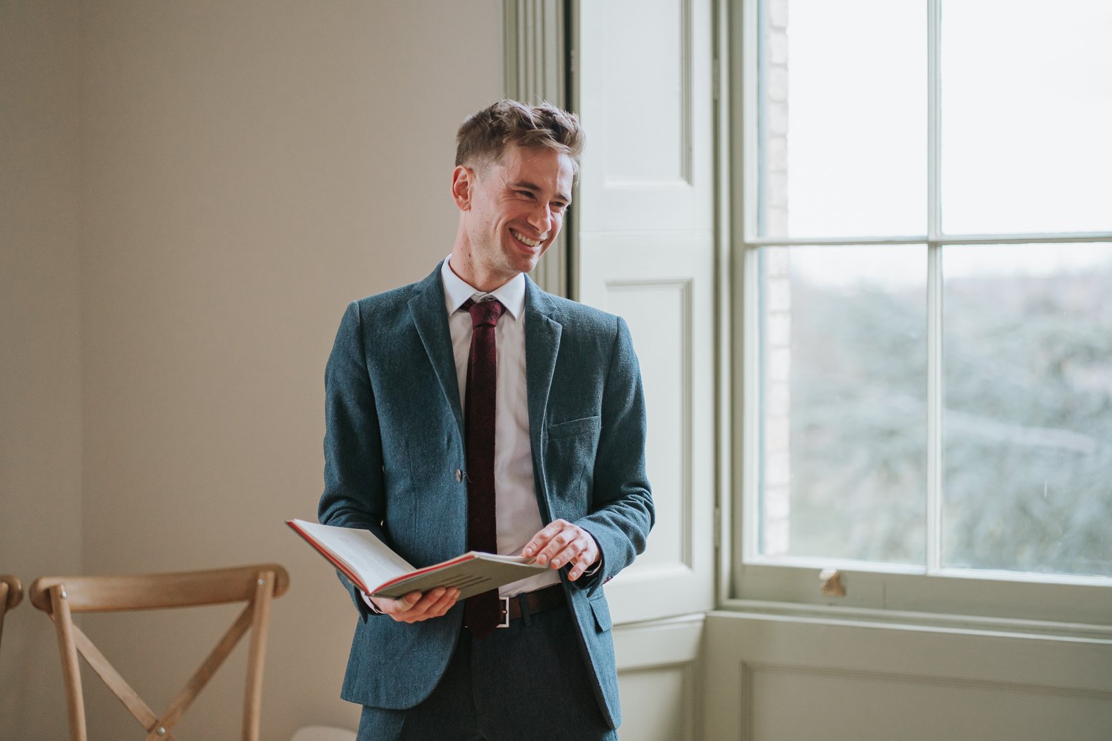  Wedding registrar speaking during ceremony at Brockwell Hall, intimate indoor civil ceremony in Brockwell Park South London. 