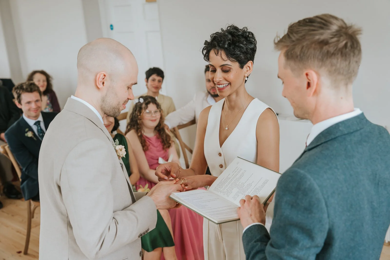  Close-up of ring exchange during Brockwell Hall wedding ceremony, emotional moment in Brockwell Park civil wedding. 