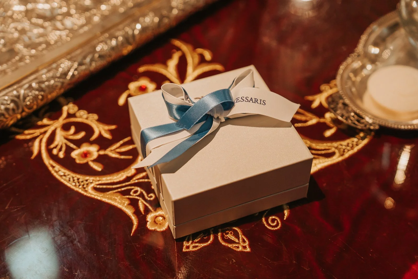  Christening favour box with blue ribbon displayed on embroidered church altar cloth during a Greek Orthodox baptism at St Nicholas Church, London. 