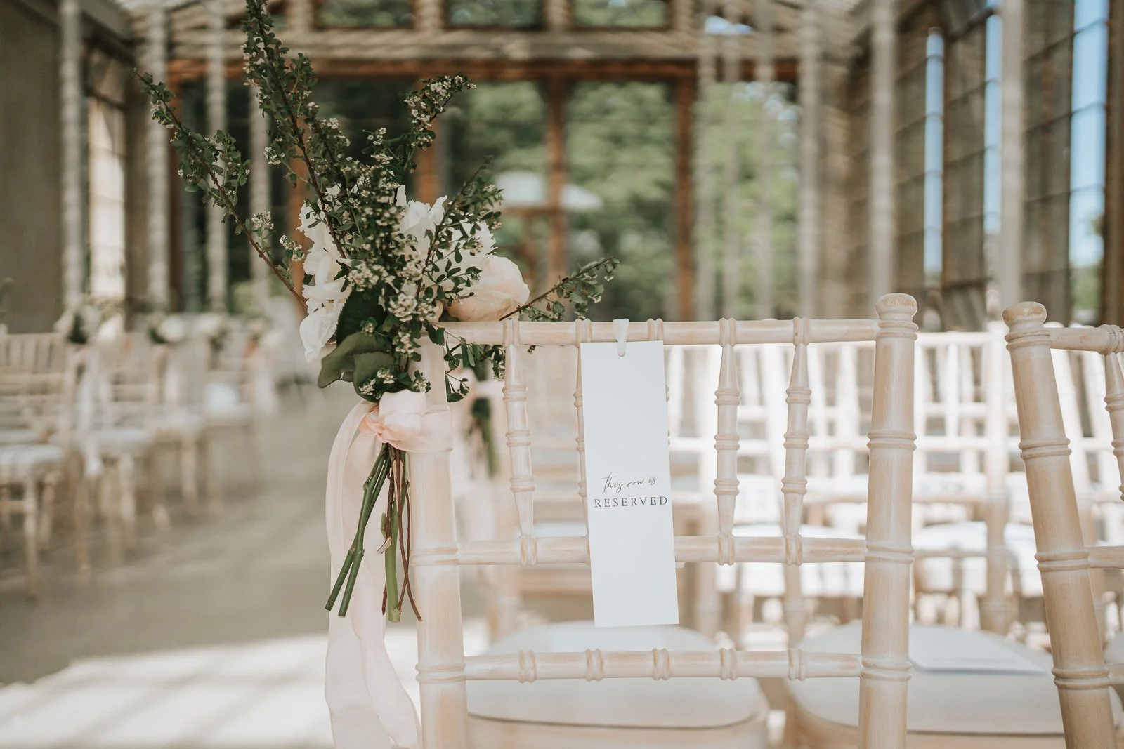  Reserved ceremony chair with floral arrangement inside The Nash Conservatory at Kew Gardens 