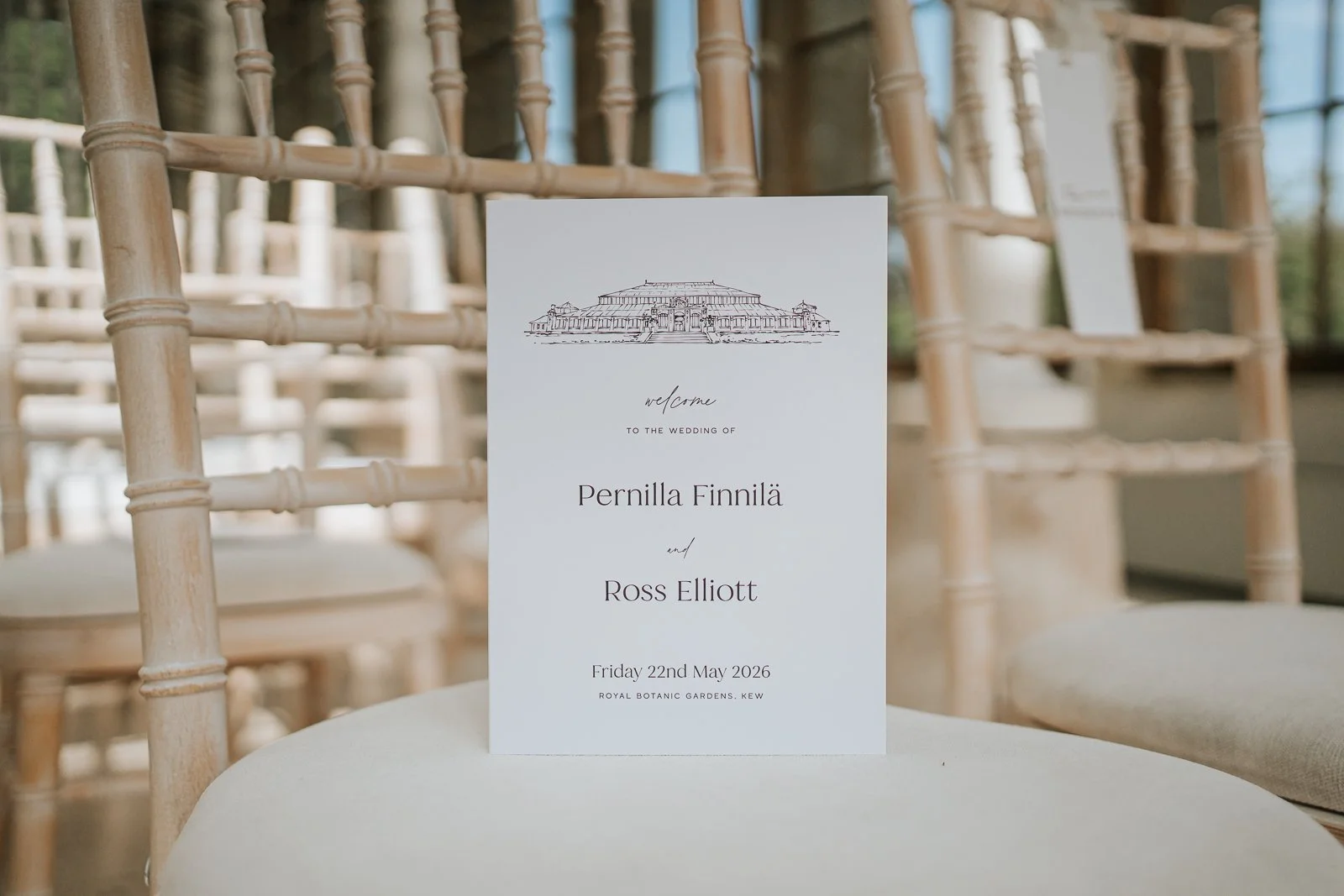  Wedding ceremony programme on a chair at The Nash Conservatory, Kew Gardens London. 
