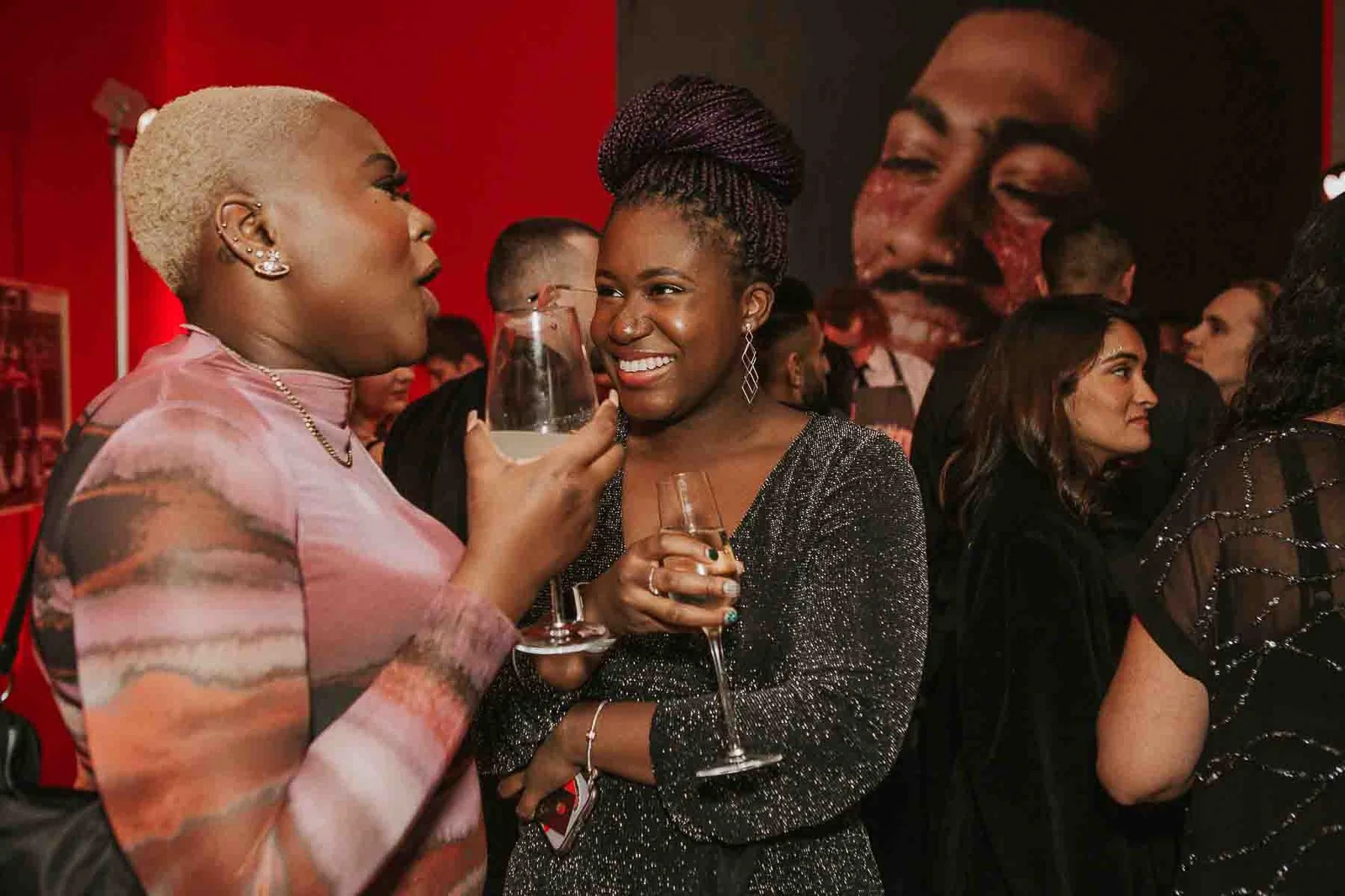  Friends chatting and laughing over drinks at a stylish 30th birthday celebration in London, photographed with a natural documentary approach. 