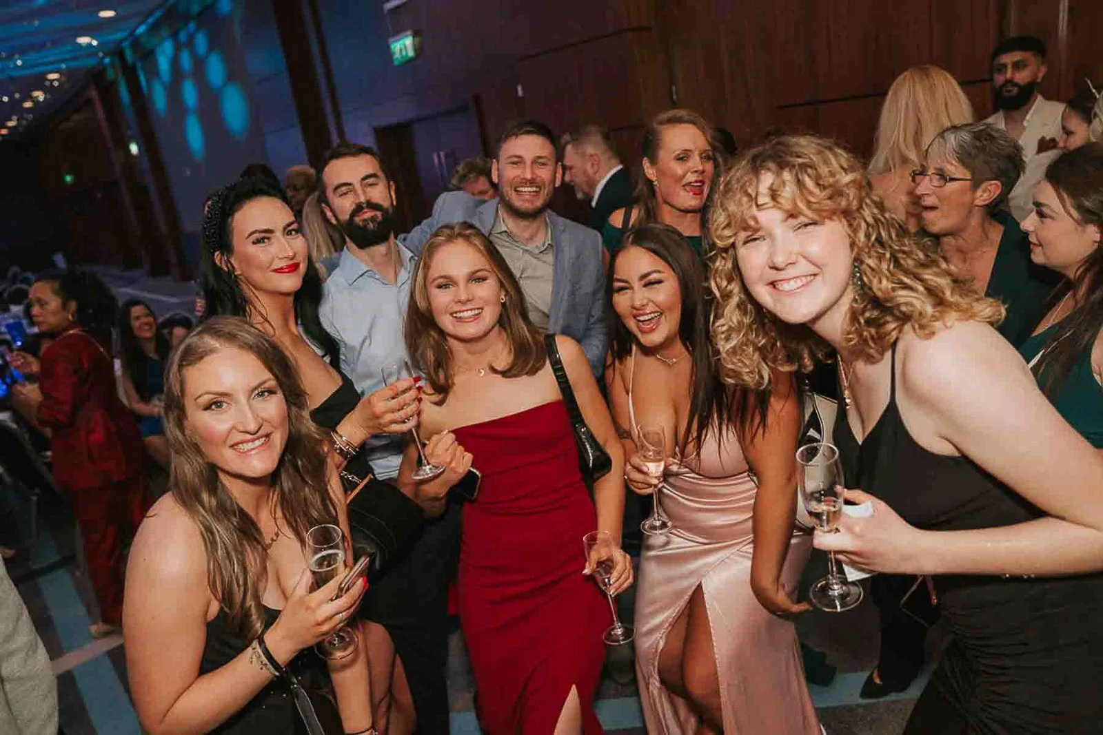  Friends posing together with champagne at a milestone birthday celebration, photographed by a London birthday party photographer. 