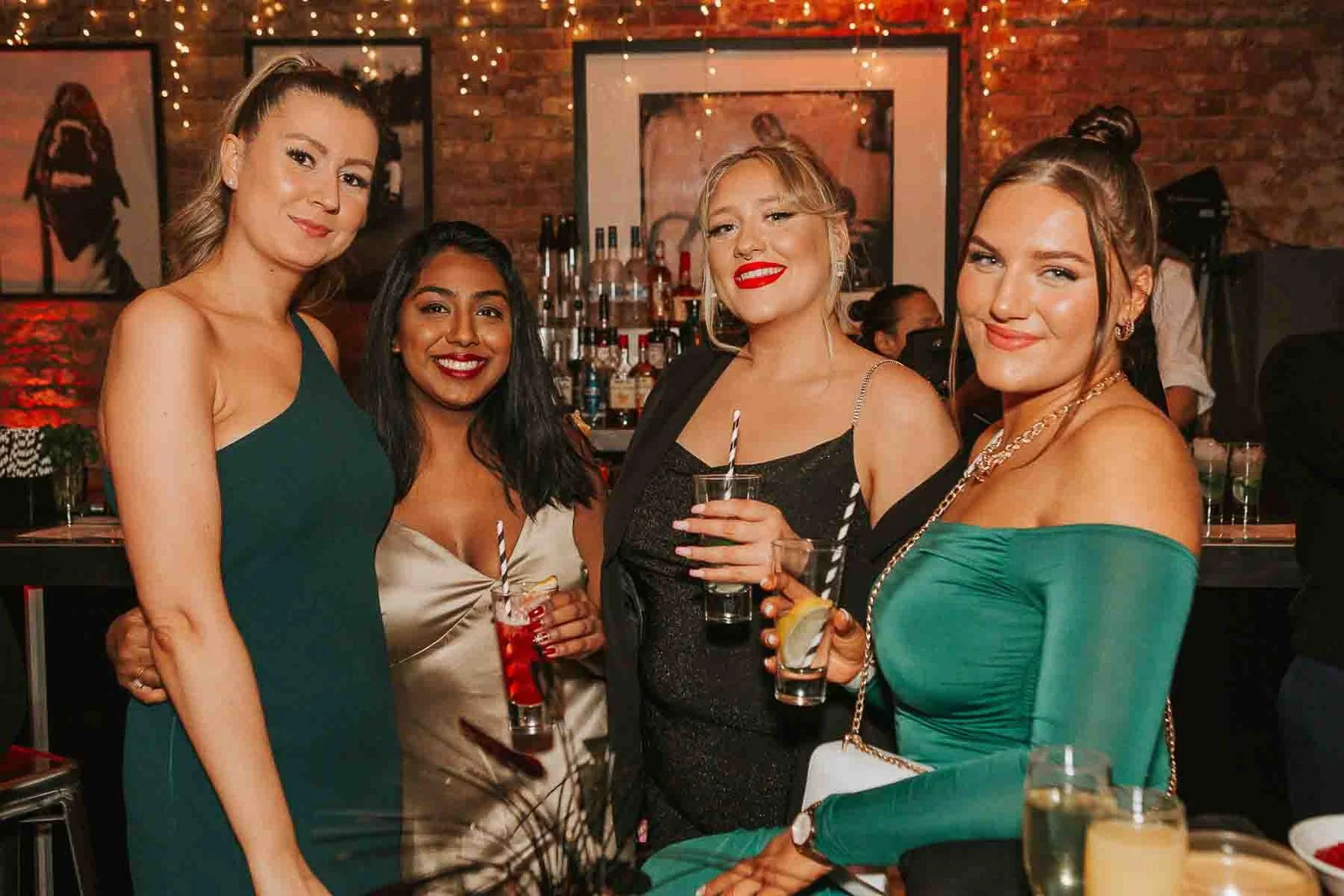  Group portrait of friends enjoying cocktails and conversation at a stylish 30th birthday party venue in South London. 