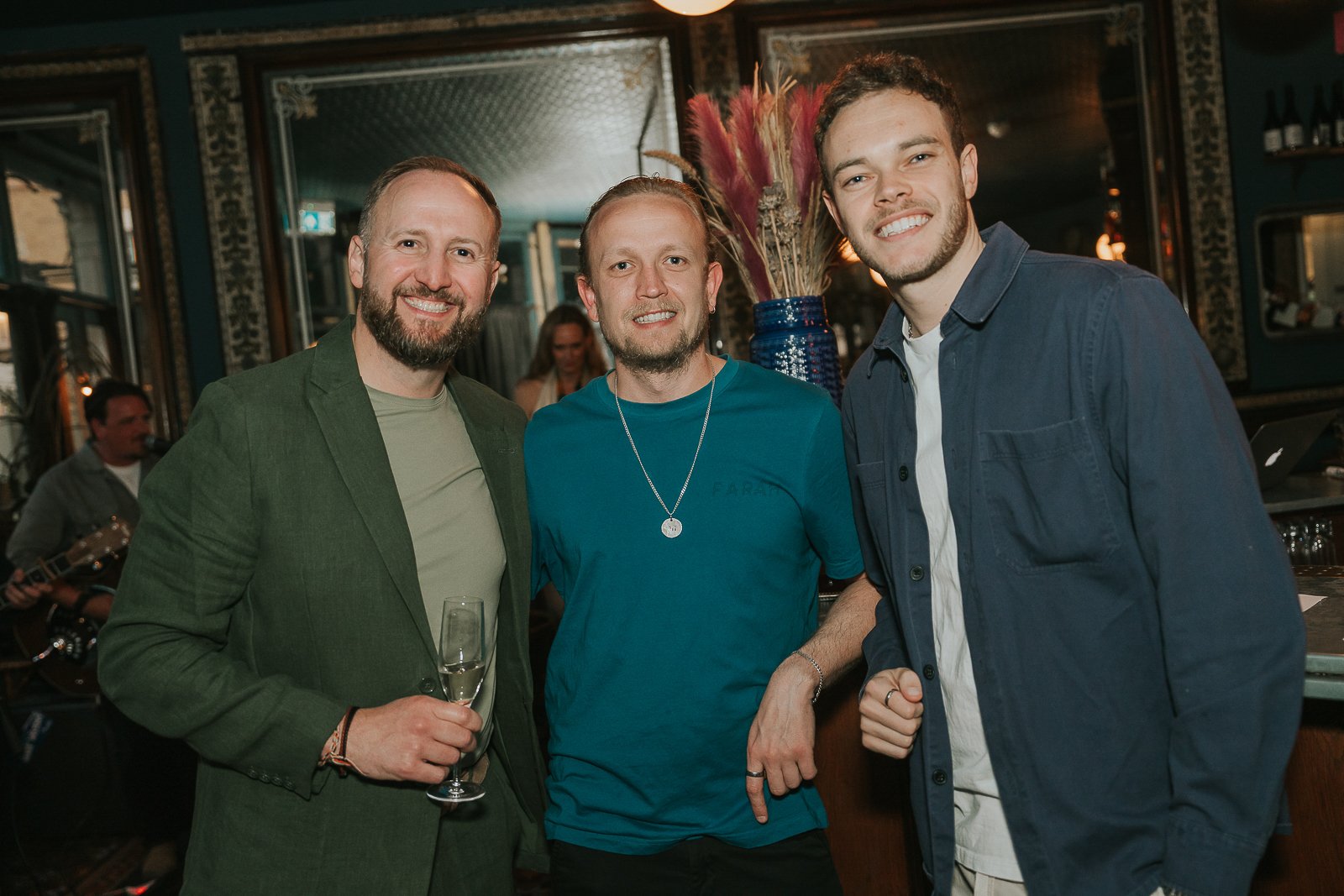  Friends posing together during a relaxed 40th birthday gathering, captured with natural documentary-style event photography. 