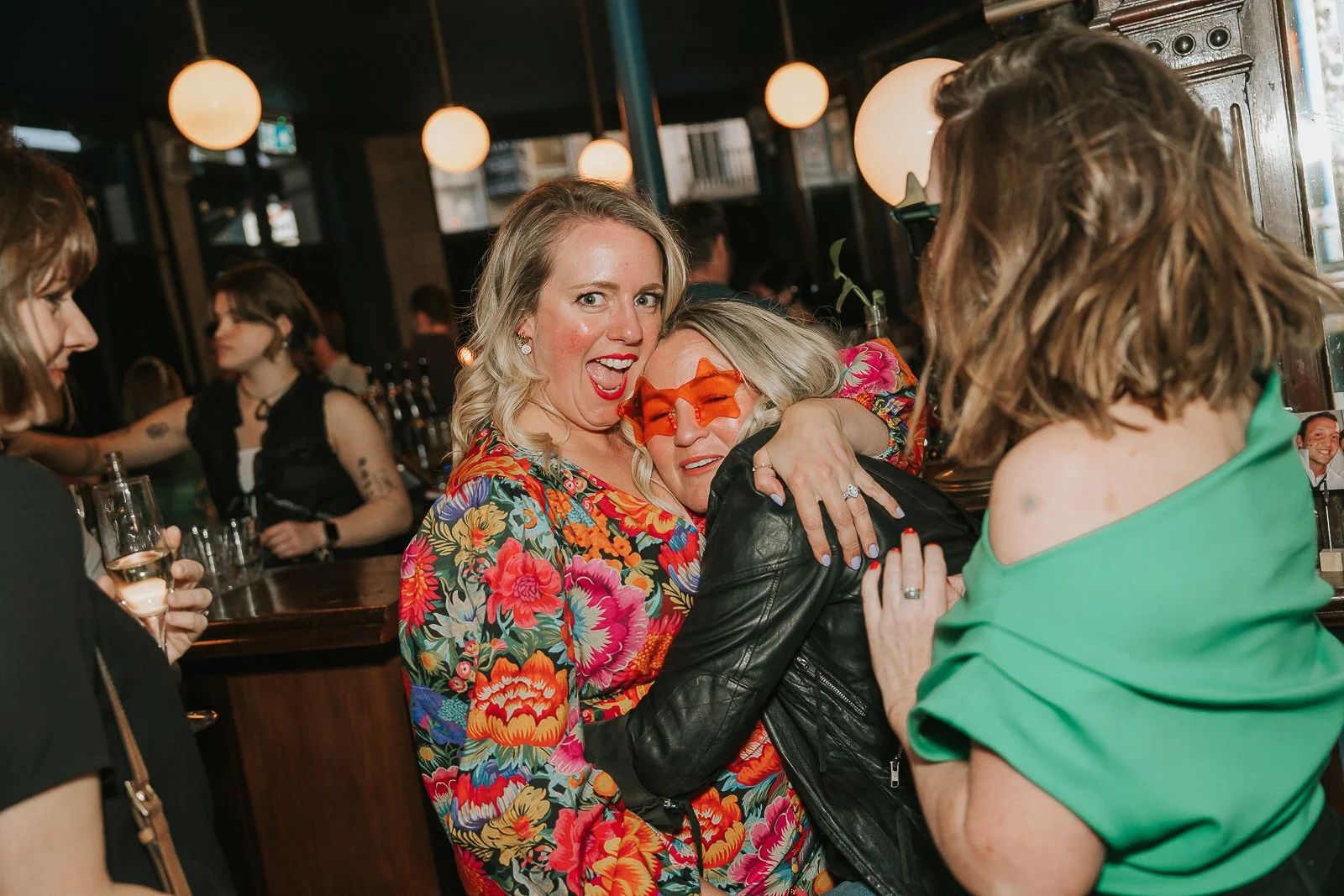  Friends sharing a hug and enjoying the party atmosphere at a fun-filled 40th birthday event in South London. 