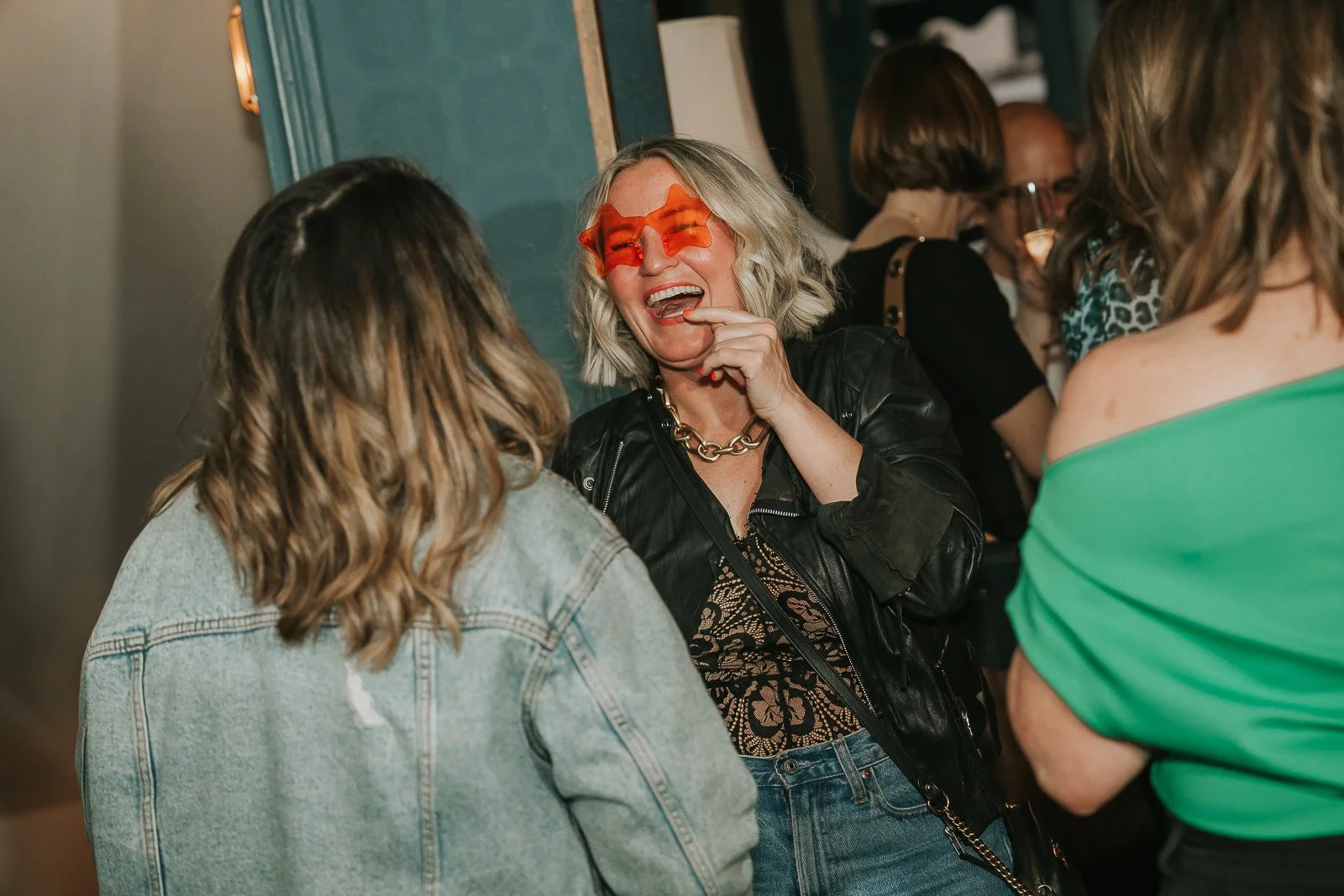  Birthday guests laughing together during a relaxed 40th birthday celebration at a private London venue. 