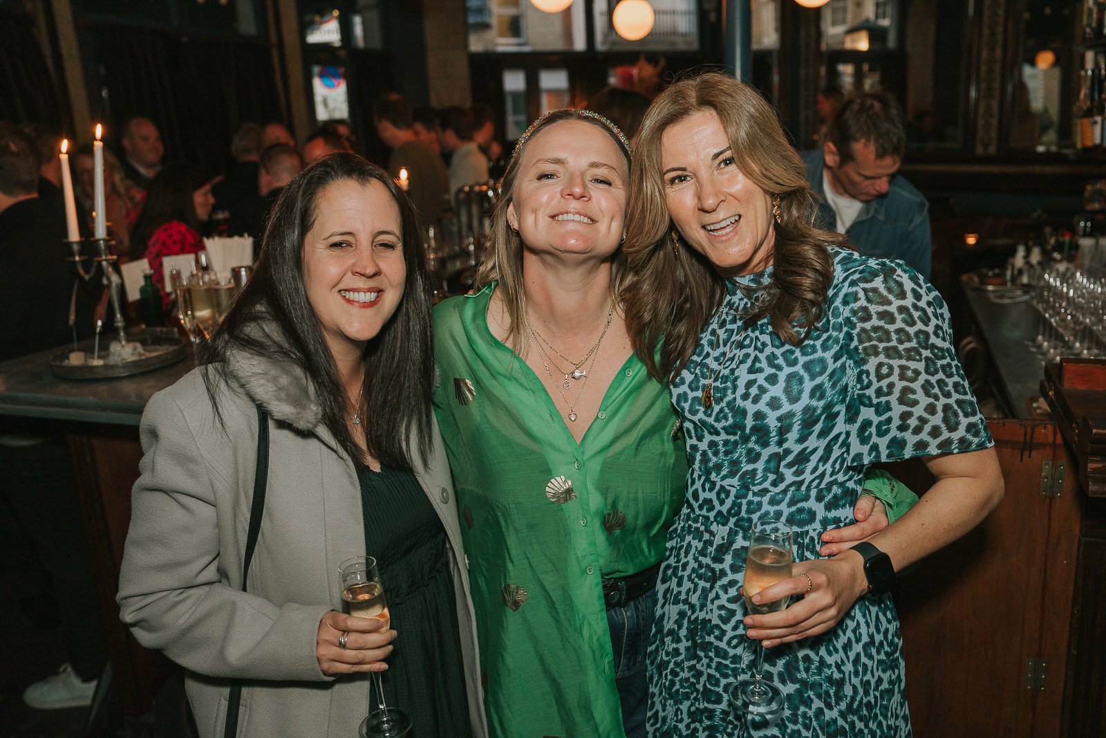  Friends posing together during a relaxed 40th birthday gathering, captured with natural documentary-style event photography. 
