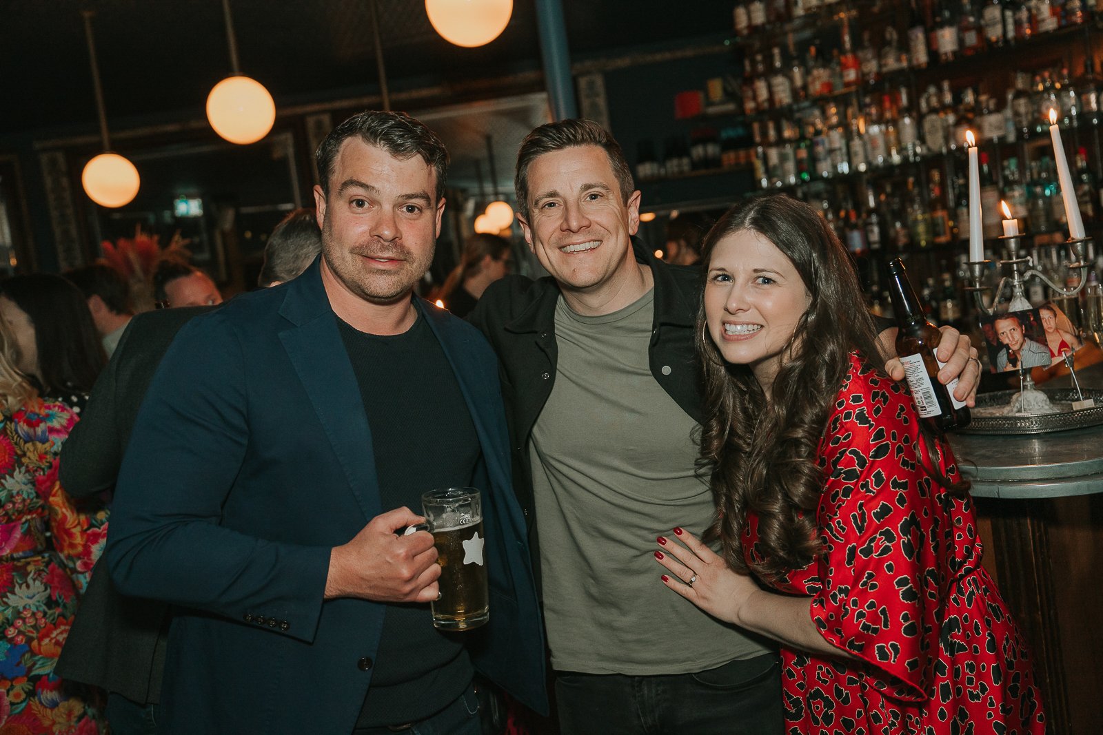  Friends posing together during a relaxed 40th birthday gathering, captured with natural documentary-style event photography. 