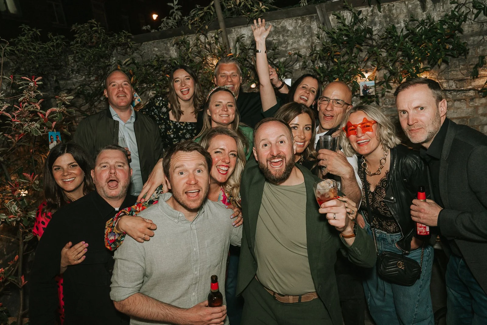   Large group of friends and family celebrating a 40th birthday party outdoors on a summer evening in London.  