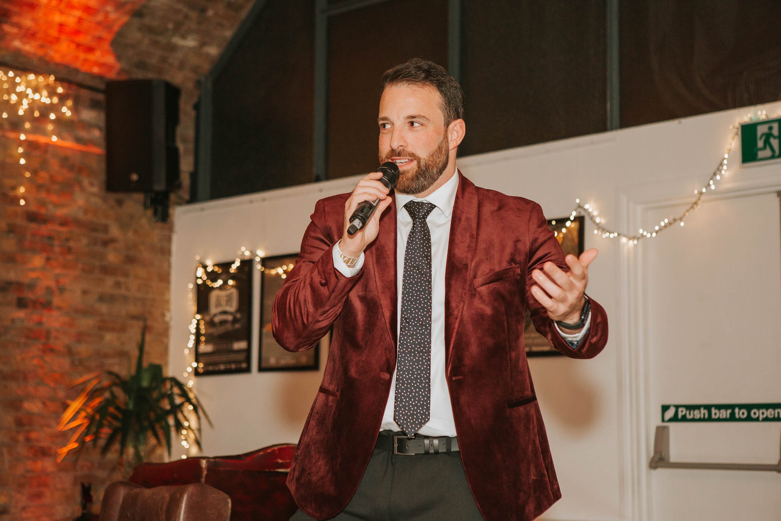  Birthday party host giving a speech at a stylish London venue, captured by a documentary birthday party photographer during a 40th birthday celebration. 