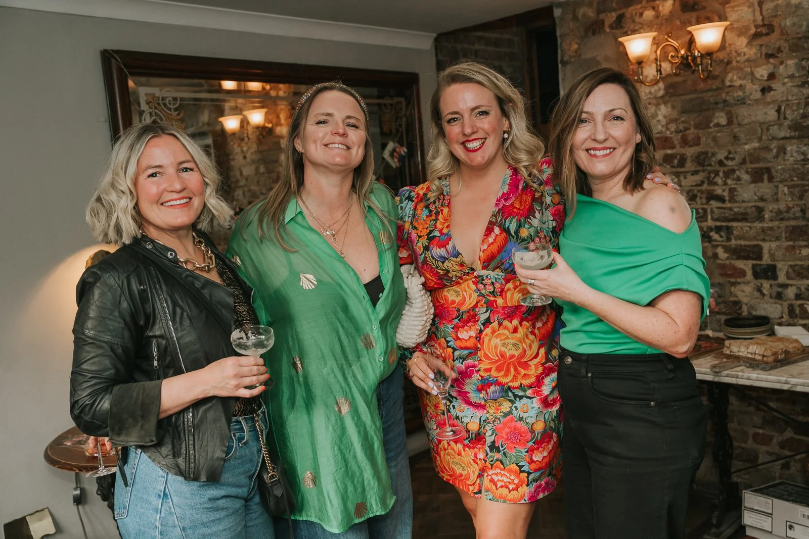  Group portrait of friends at a 40th birthday party, photographed in a relaxed documentary style at a London venue. 