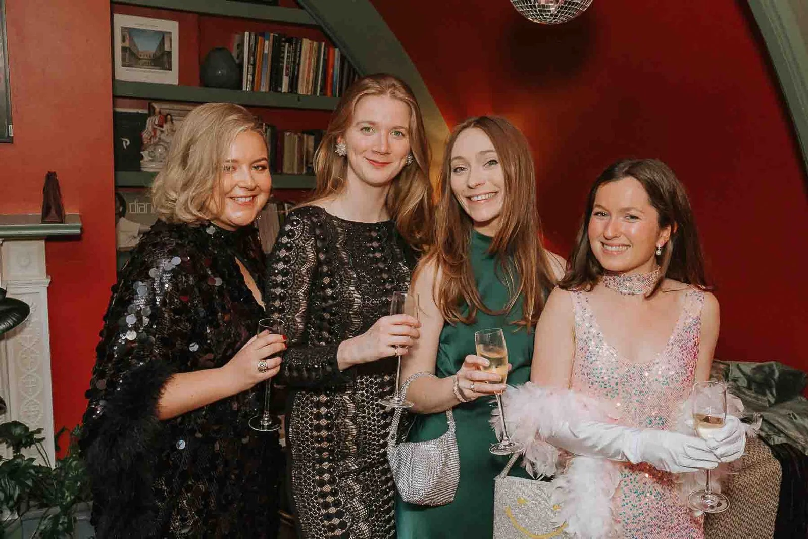  Four friends enjoying drinks and celebrating together at a 30th birthday party in London, captured with natural event photography. 