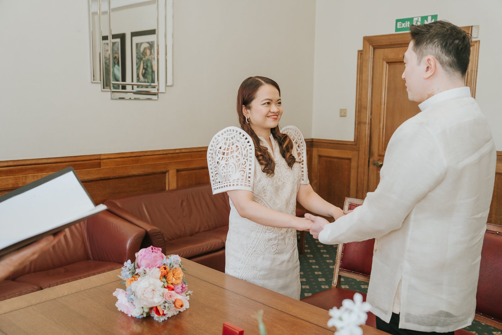  Couple exchanging vows in The Elizabeth Room at Wandsworth Town Hall during a relaxed South London civil wedding ceremony. 