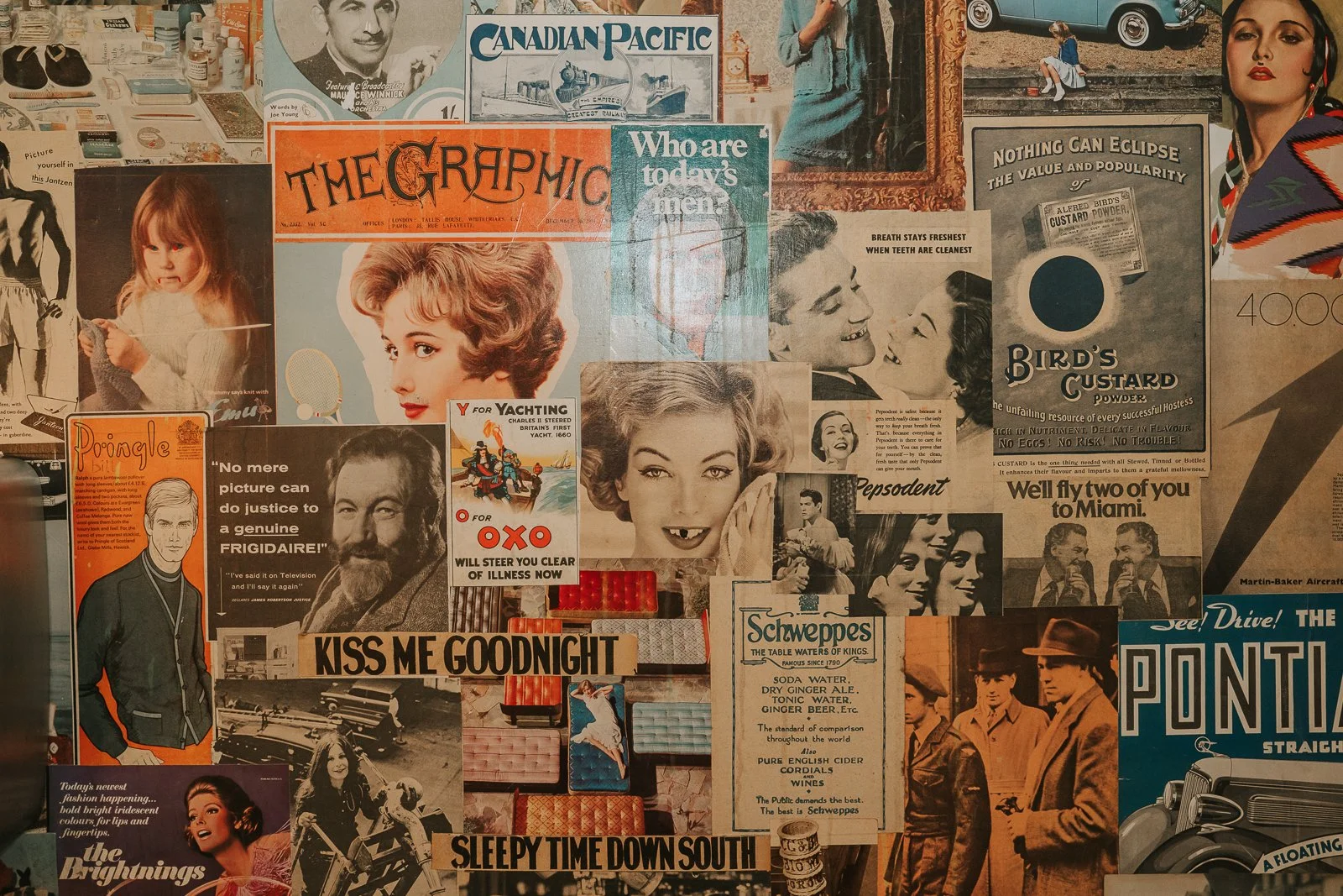  Vintage-inspired collage wall featuring retro advertisements and artwork inside The Zetter Townhouse Clerkenwell wedding venue. 