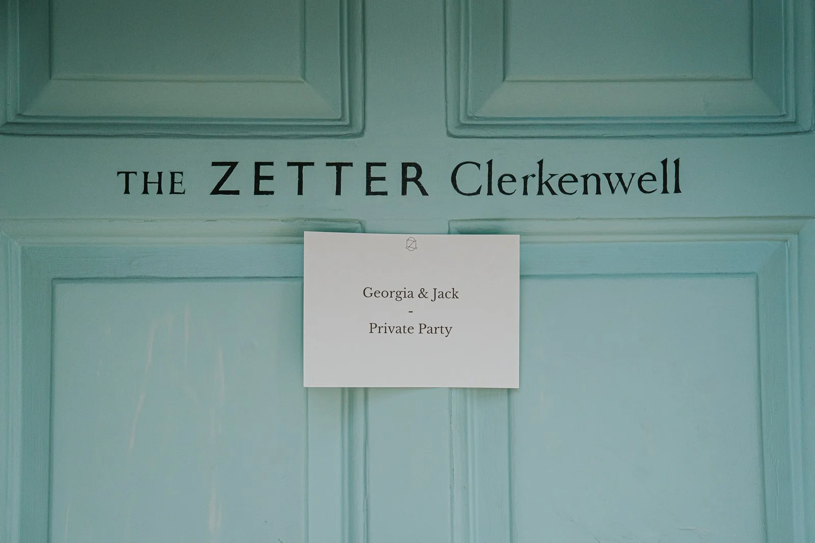  Personalised wedding party sign for Georgia and Jack displayed on the pastel blue entrance door of The Zetter Clerkenwell. 
