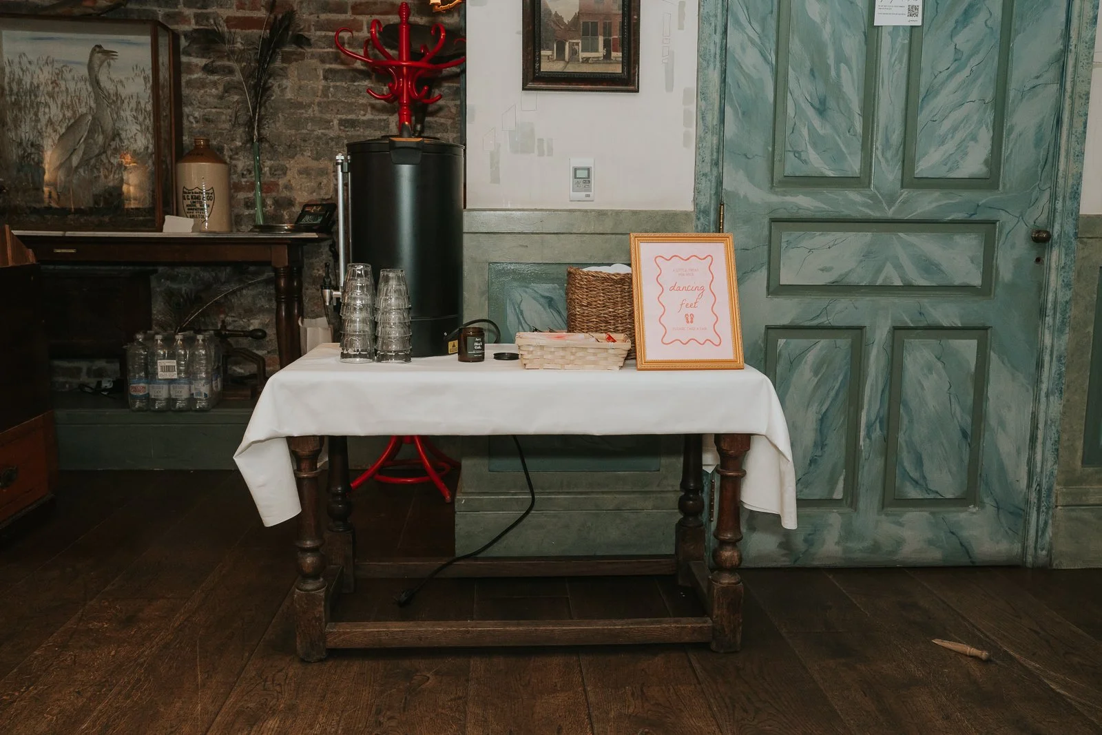  "Dancing feet" wedding favour station with slippers and refreshments set up inside The Zetter Townhouse Clerkenwell, offering guests a thoughtful touch for the evening celebration. 