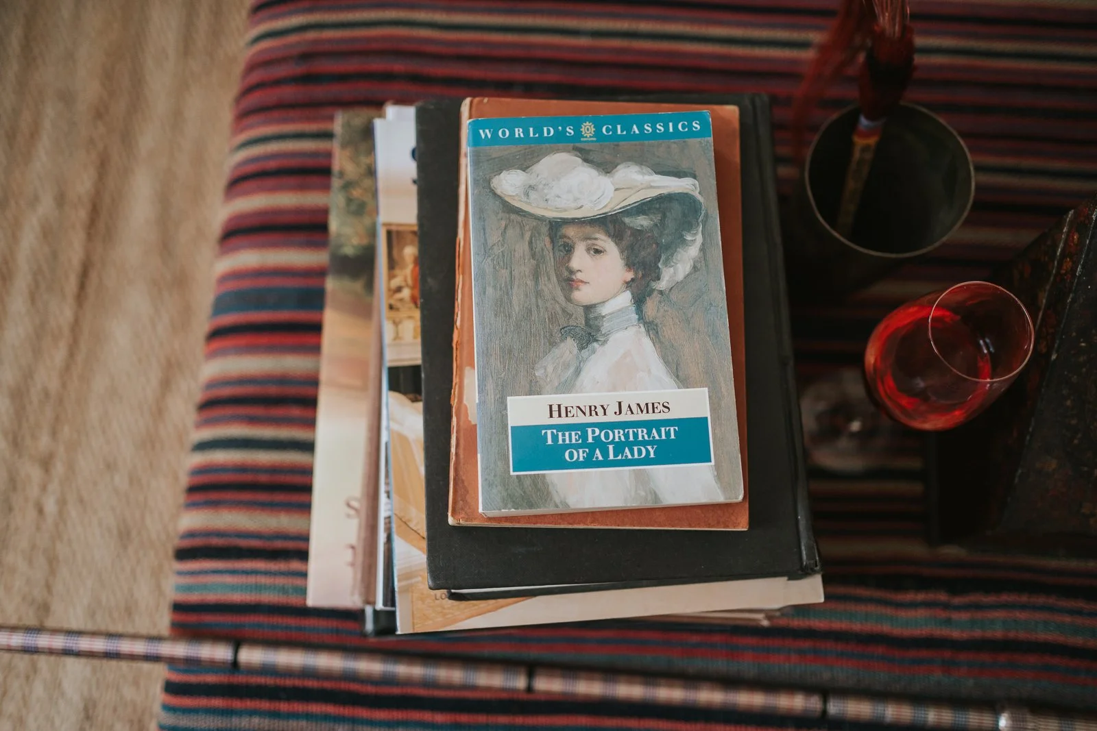  Stack of classic novels and decorative books displayed in a characterful guest room at The Zetter Townhouse Clerkenwell wedding venue. 