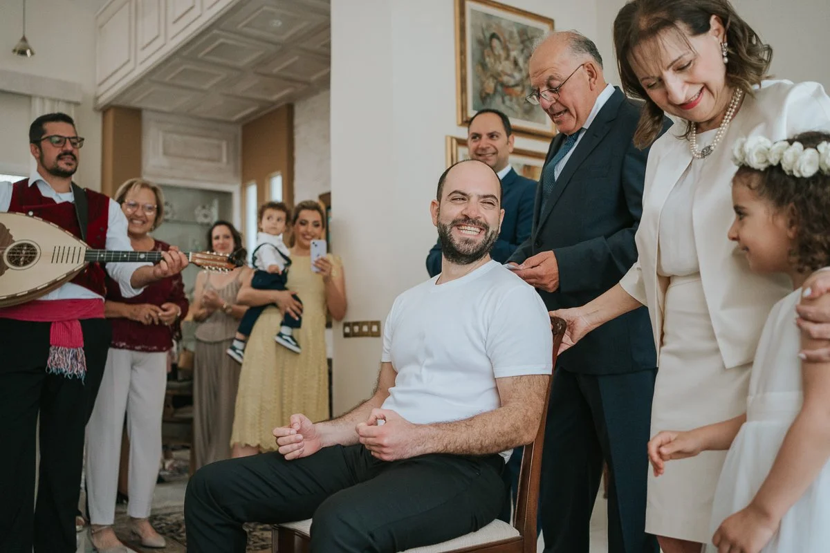  Traditional Greek wedding preparations with live musicians performing during the groom's stolisma while family and friends watch and take part in the celebrations. 