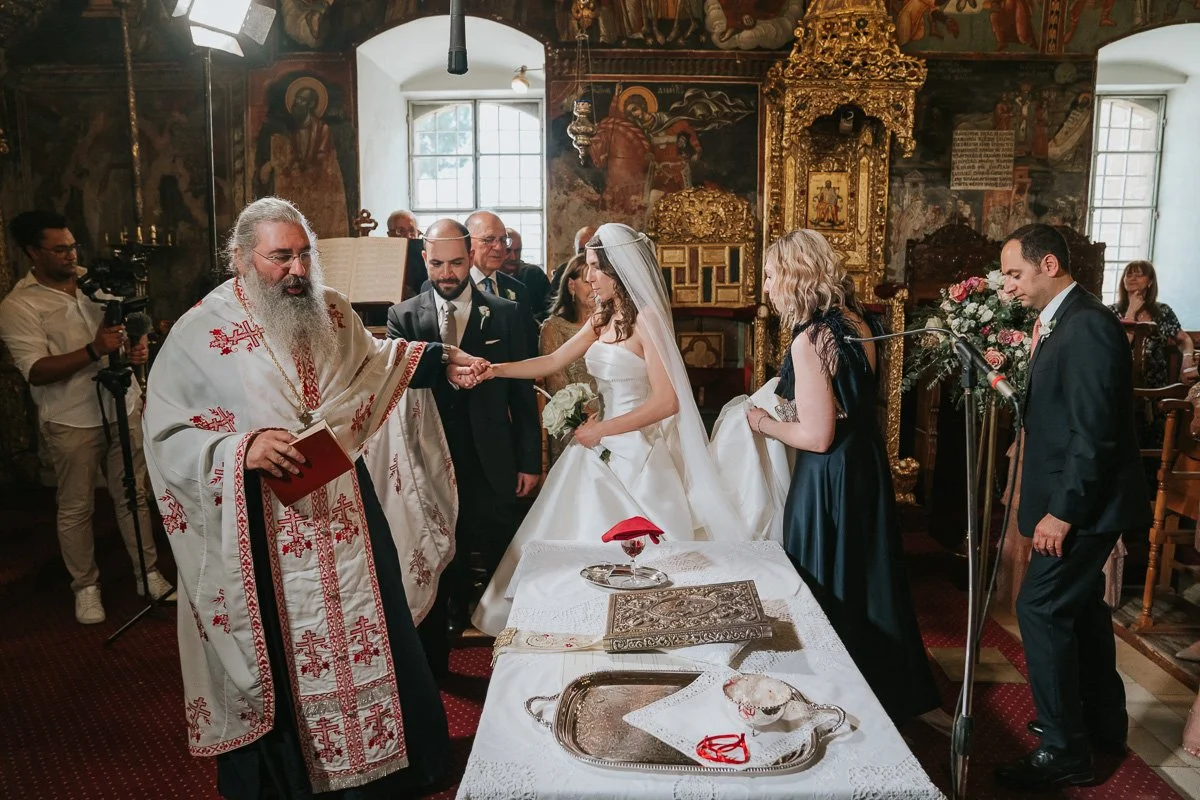 A Greek Orthodox wedding ceremony as the priest leads the bride and groom around the altar in celebration of their marriage. 