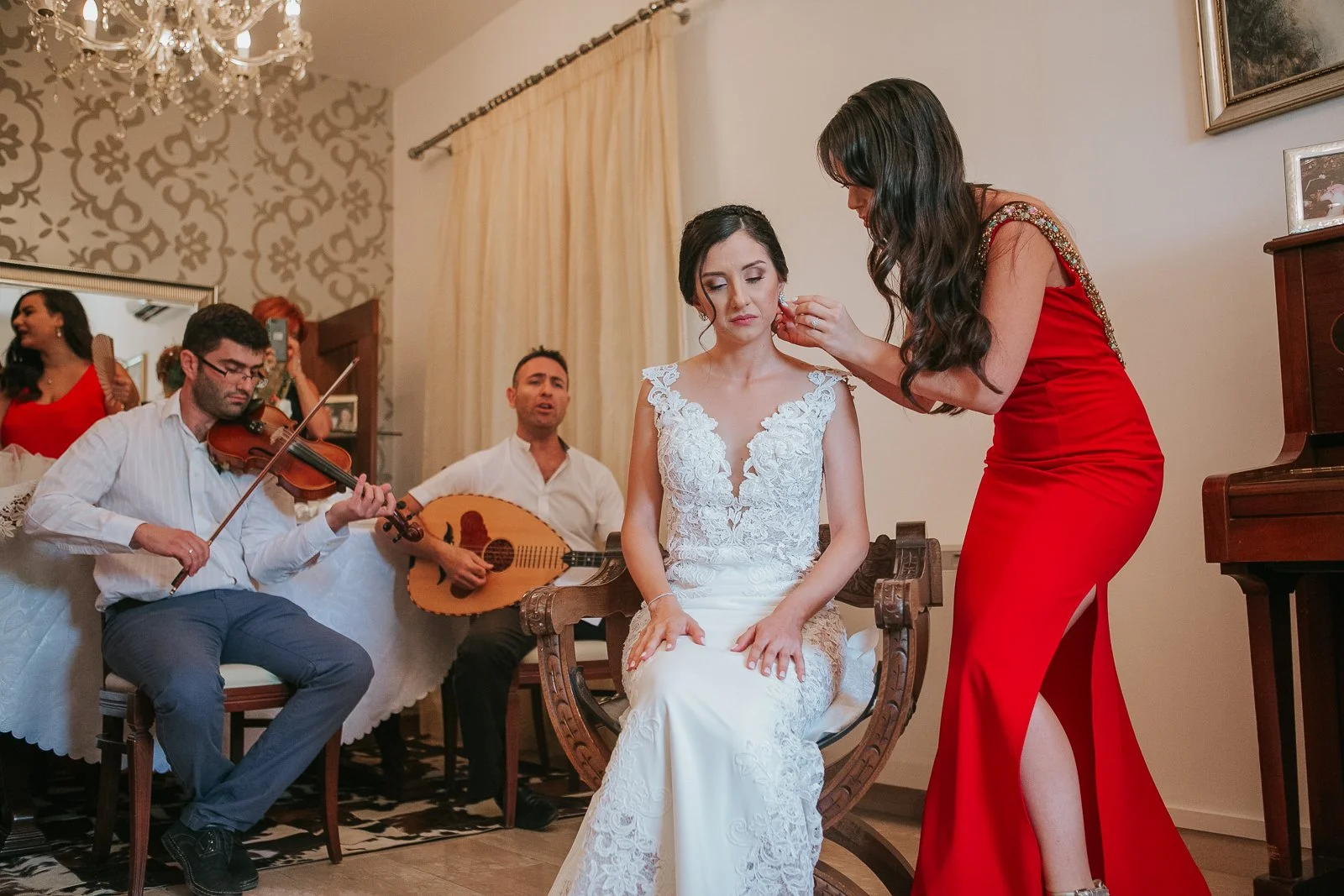  Final touches during a Greek Orthodox stolisma as the bride's jewellery is adjusted before leaving for the church ceremony. 