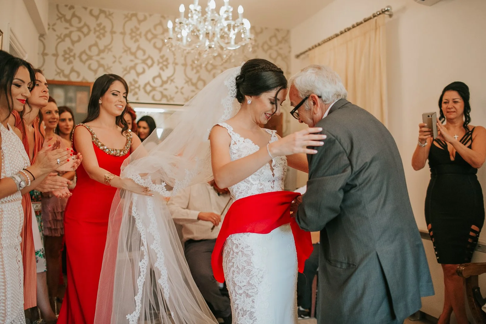  Bride embracing her father during an emotional Greek Orthodox stolisma as family members gather to celebrate before the wedding. 