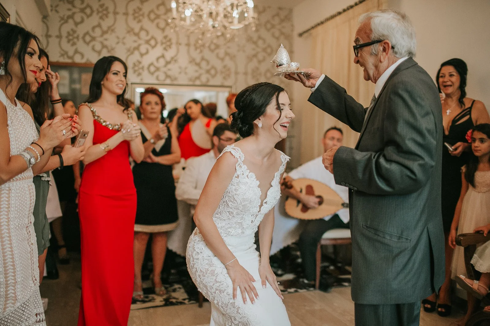  Bride receiving a traditional family blessing during her Greek Orthodox stolisma before departing for the church ceremony. 