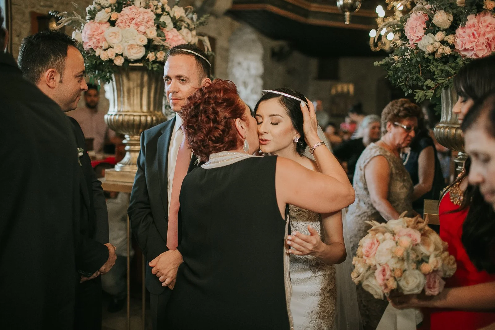  Emotional moment as family members congratulate the bride and groom following their Greek Orthodox wedding ceremony. 