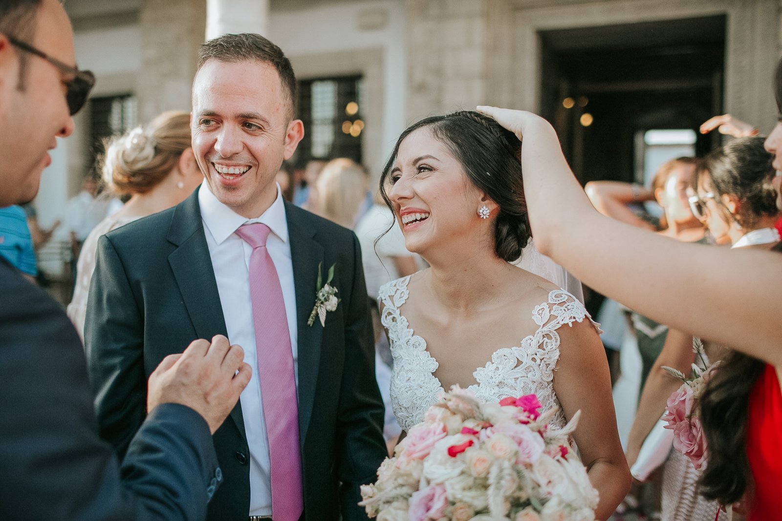  Newlyweds laughing with family and friends outside a Greek Orthodox church moments after the wedding ceremony in London. 