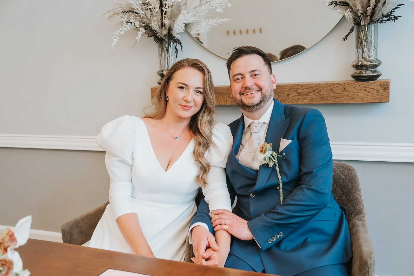  Newly married couple seated together after their ceremony in Room 99 at Islington Town Hall. 