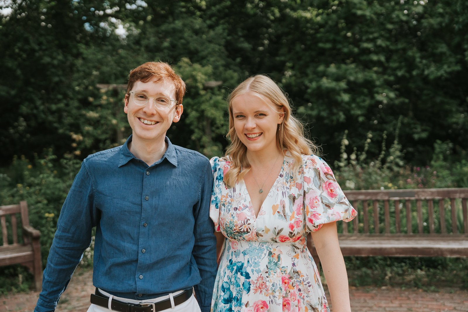  Natural engagement portrait in Battersea Park, London, featuring a smiling couple standing together among the park's beautiful gardens and pathways. 