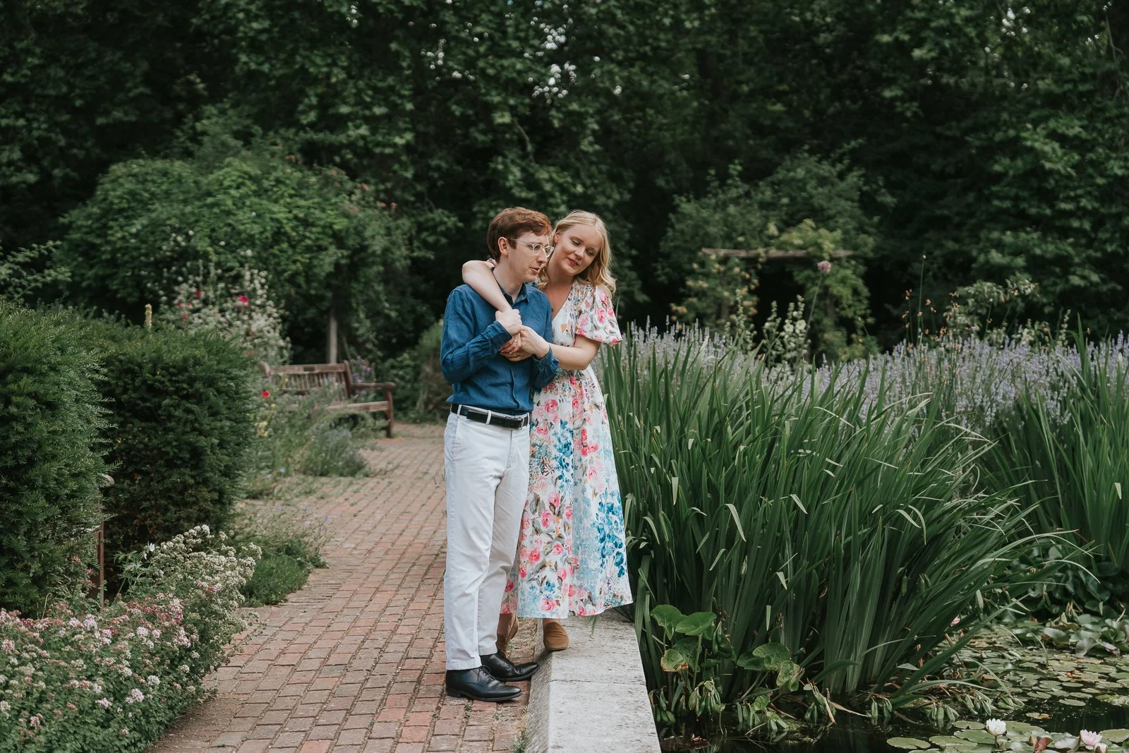  Romantic pre-wedding portrait in Battersea Park, London, showing a couple sharing a quiet moment beside the ornamental gardens and water features. 
