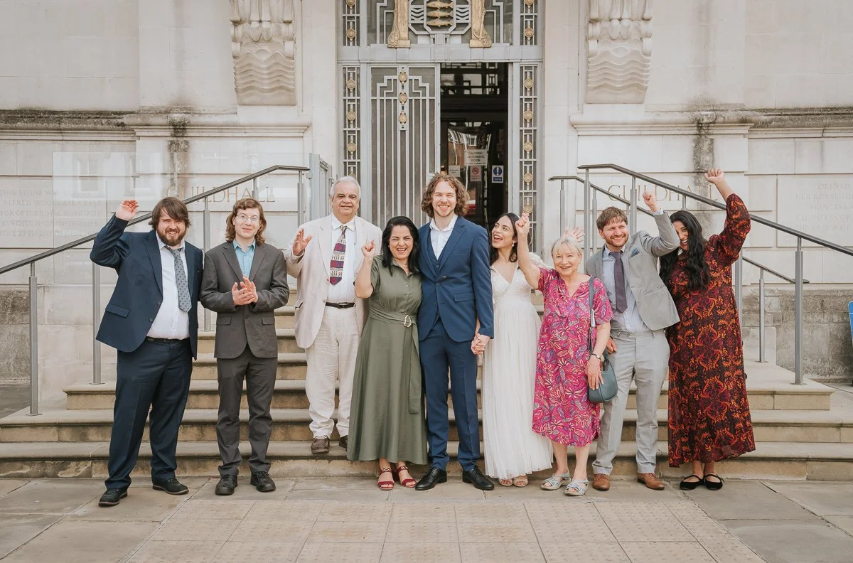  Wedding guests celebrating with the newly married couple on the steps outside Kingston Register Office after the ceremony. 