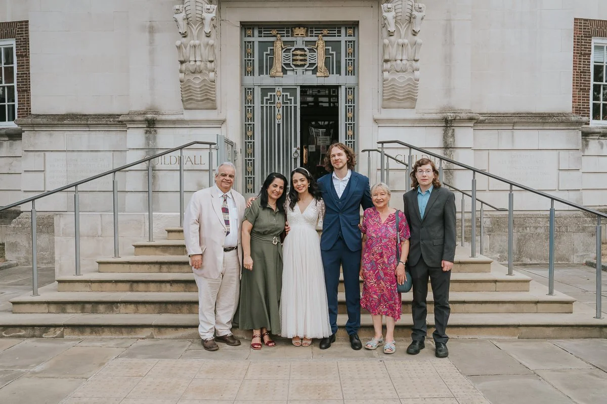  Family group portrait outside Kingston Register Office following an intimate civil wedding in Kingston upon Thames. 
