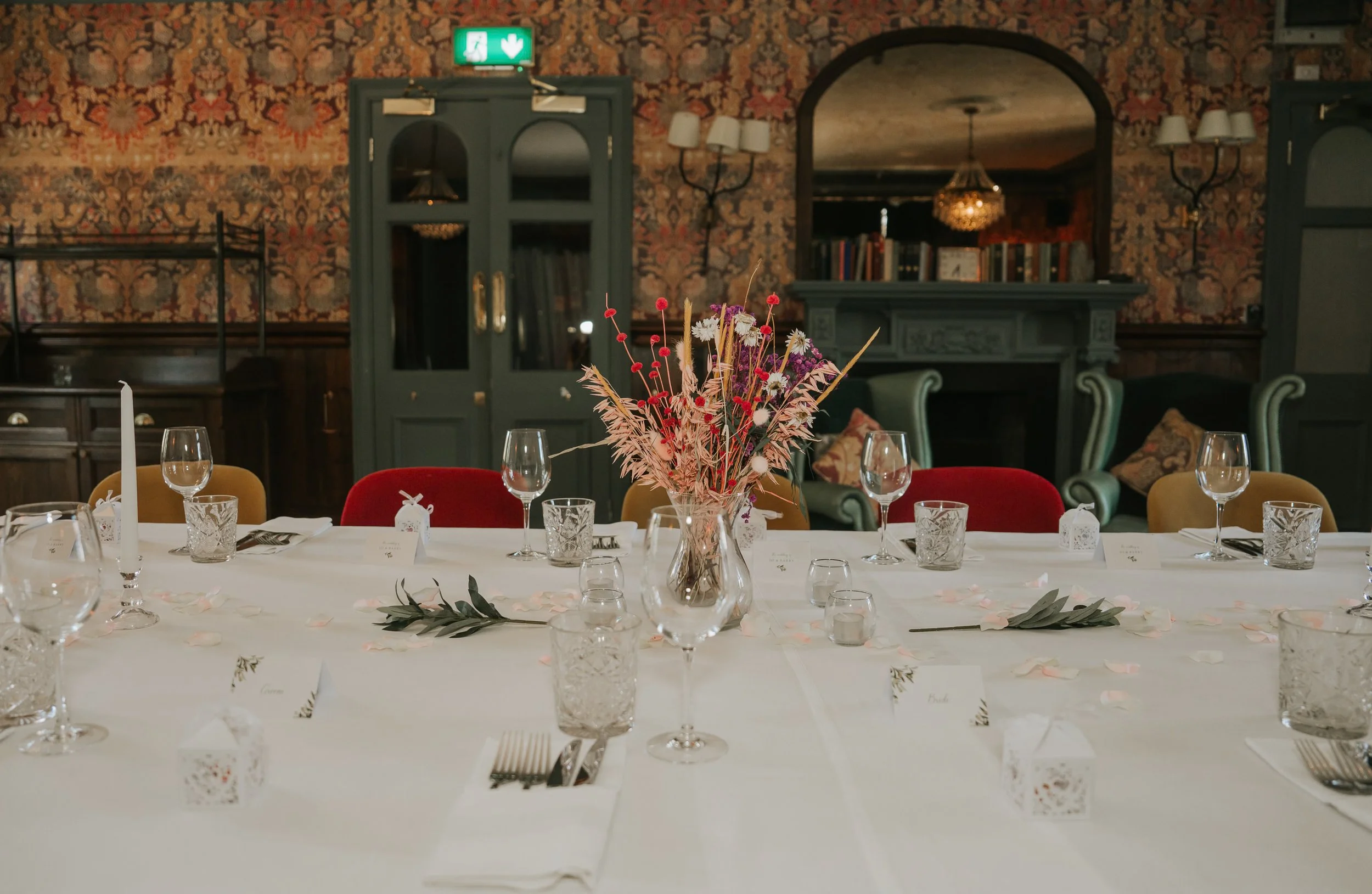  Wedding table decorated with dried flowers, candles and place settings inside the Trinity Room at the County Arms in Wandsworth 