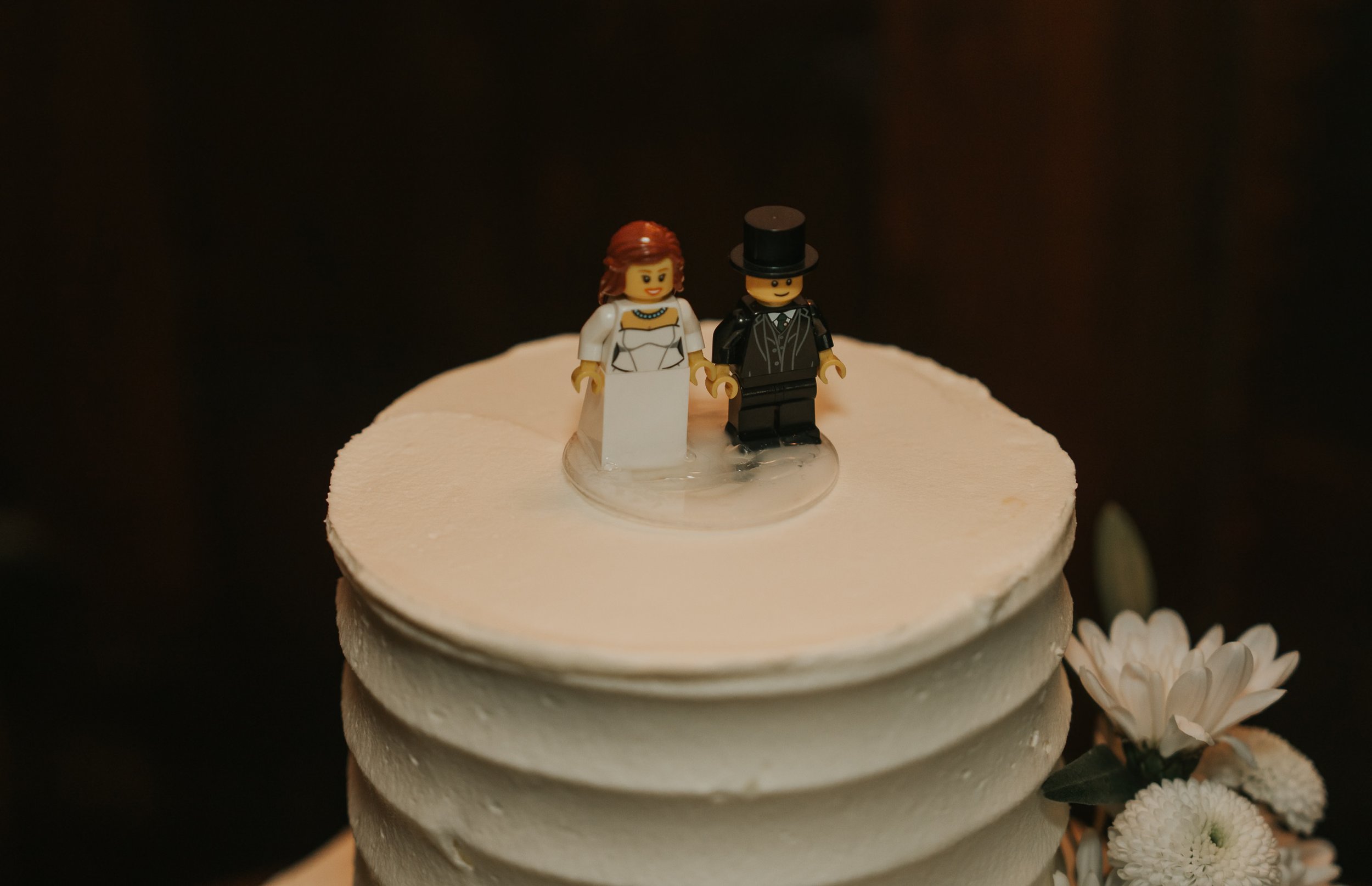  Close-up of a LEGO bride and groom cake topper on a white wedding cake at the County Arms pub in Wandsworth. 
