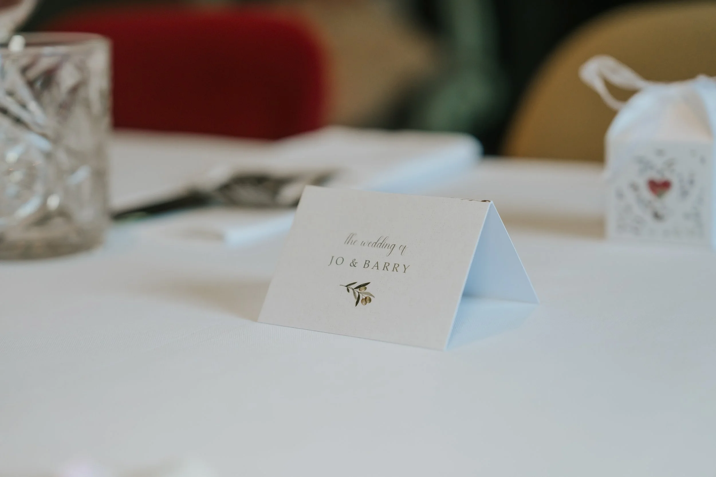  Personalised wedding place card for Jo and Barry on a reception table in the Trinity Room at the County Arms. 