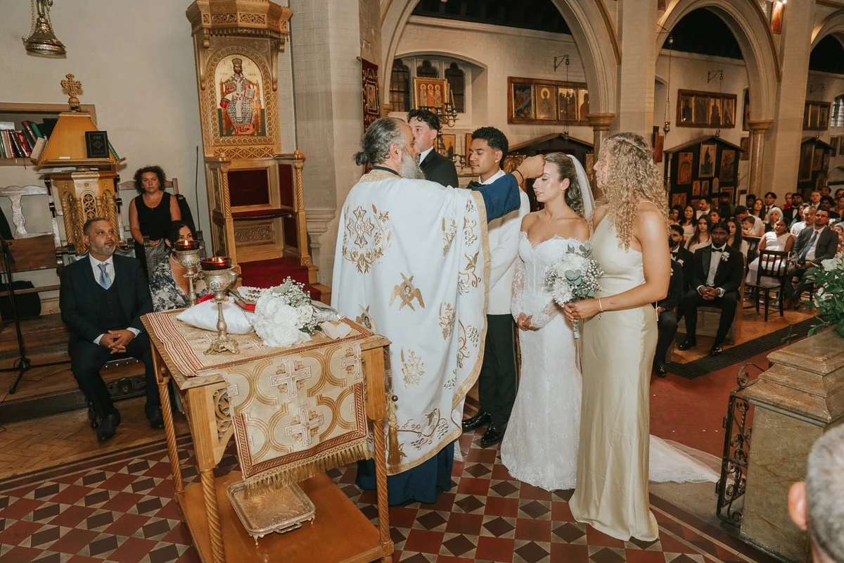  Priest placing the traditional Stefana wedding crown during a Greek Orthodox wedding ceremony at Saint Nectarios in Battersea. 