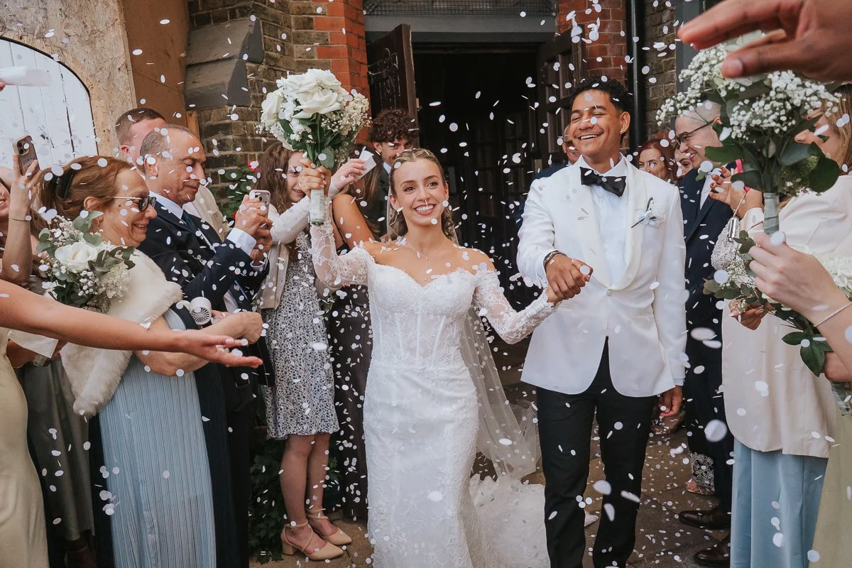  Bride and groom leaving Saint Nectarios Church in Battersea through a shower of confetti after their Greek wedding. 