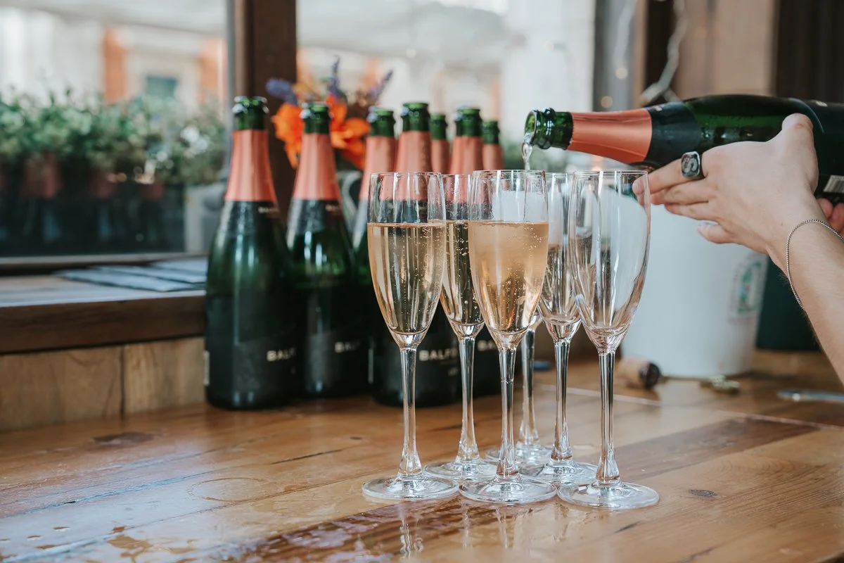  Champagne being poured for guests at a wedding reception at Balfour St Barts in Smithfield, London. 